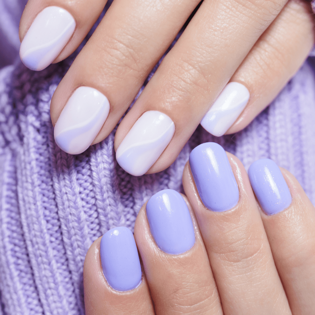 Builder gel nails with lilac on one hand and a lilac and white split design on the other, finished to a high shine at River Cottage Beauty Salon – beautifully styled nails in Kent.